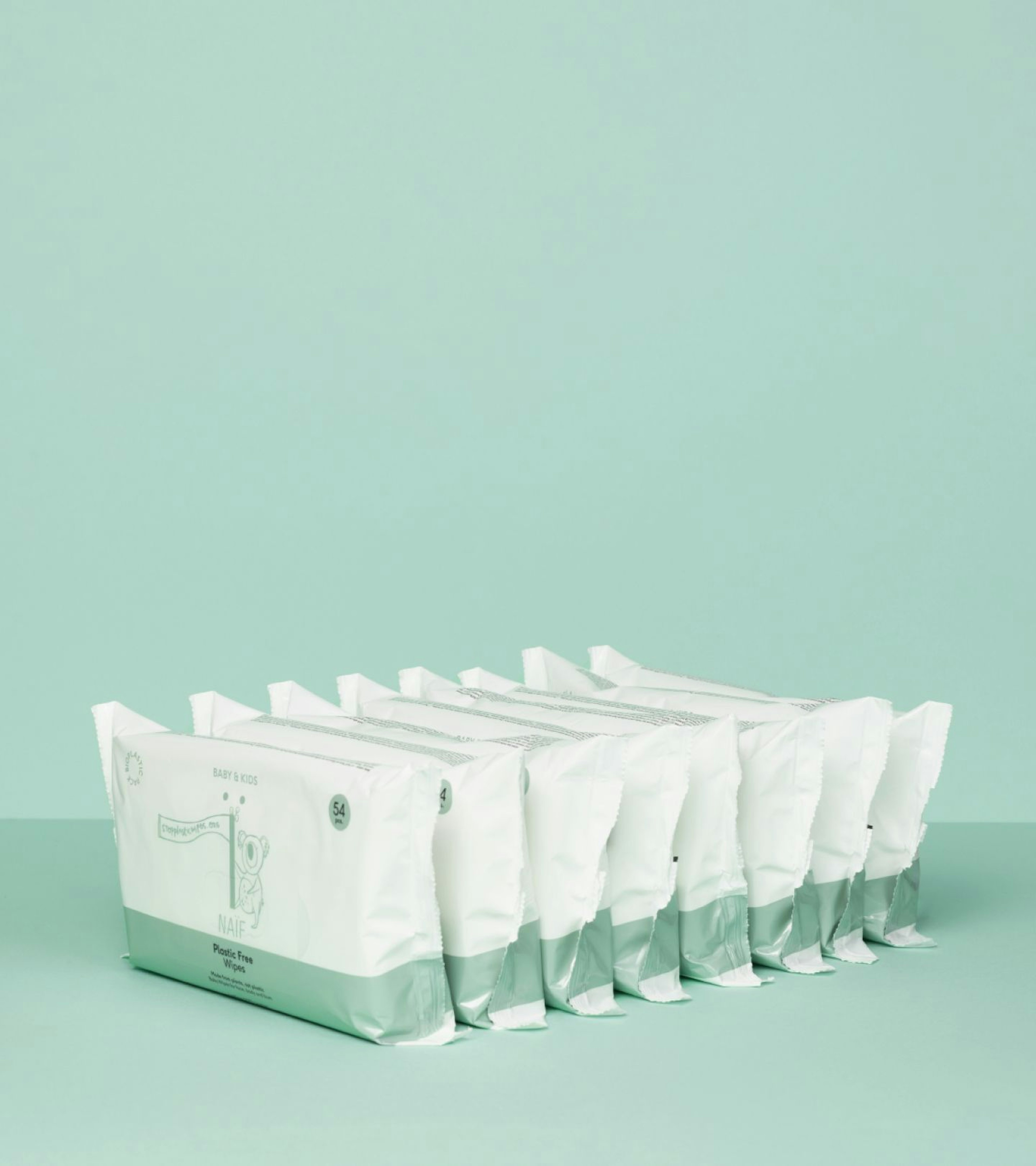 Eight Plastic Free Wipes in a row on a green background