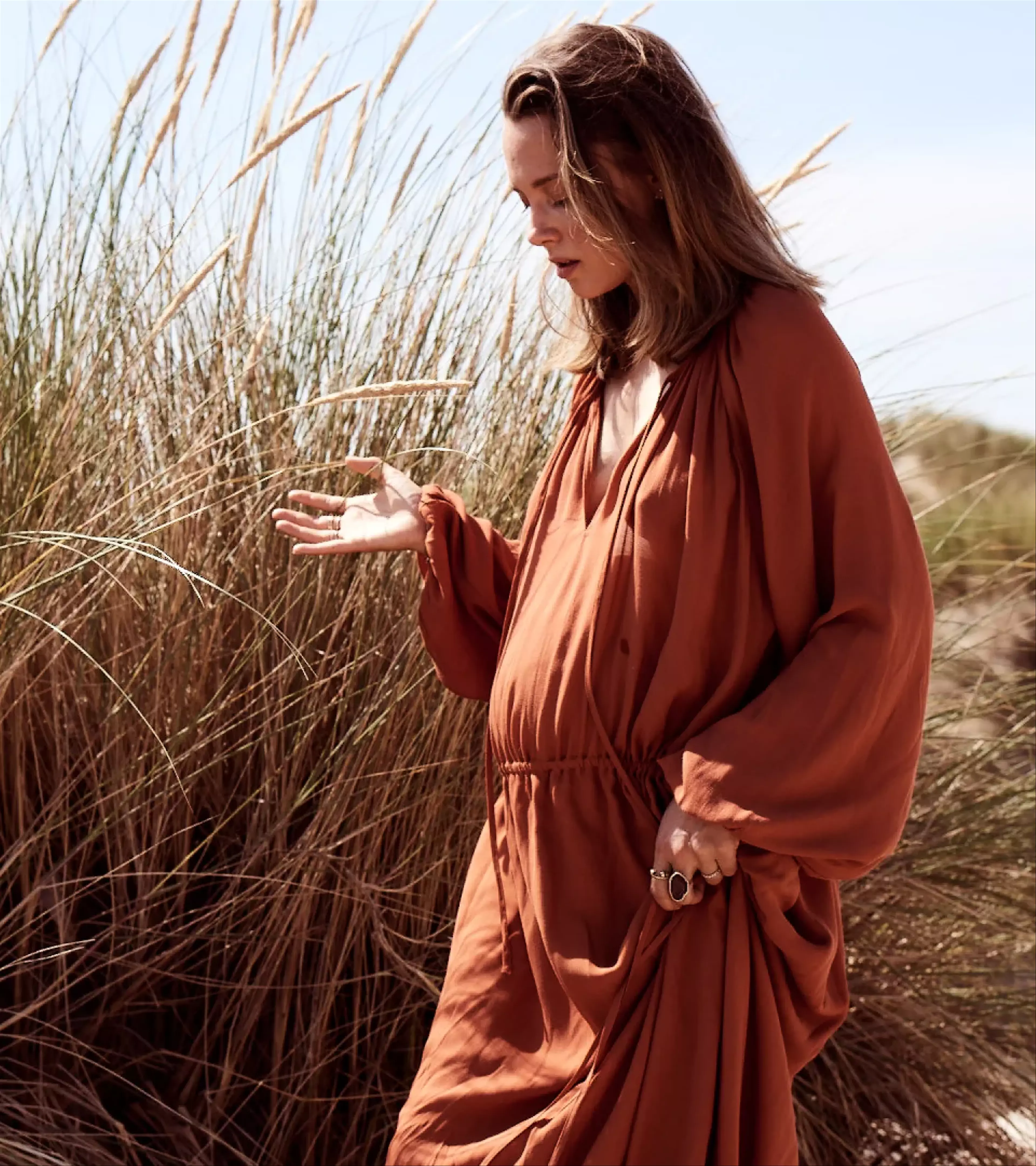 A sculpture of Nina Pierson on the beach in the dunes