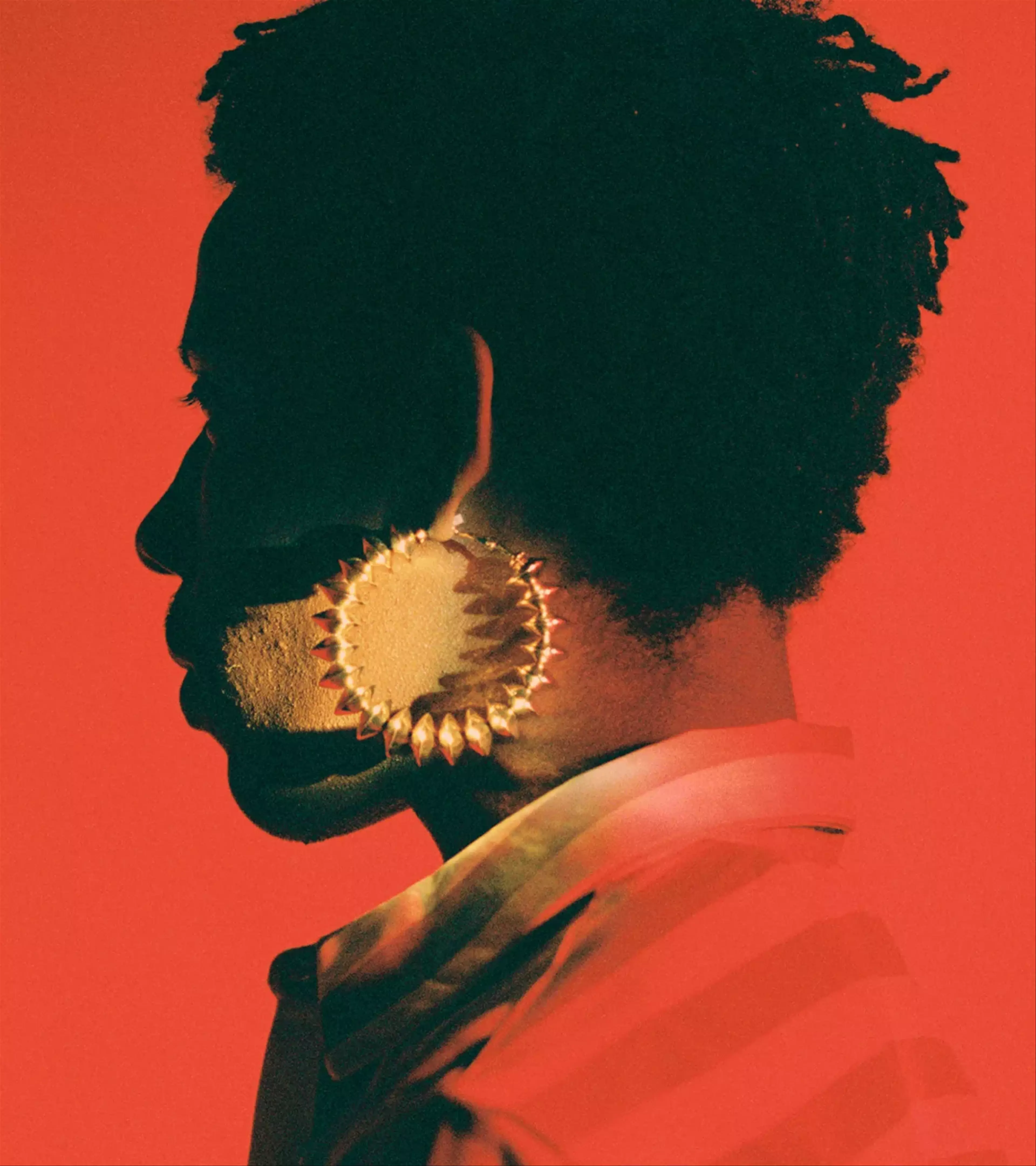 An image of a woman with a big earring on a red background