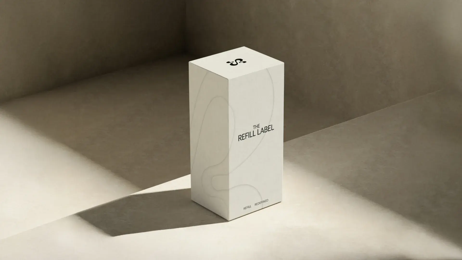 Minimalist beige box labeled "The Refill Label" placed in soft, angled lighting on a textured surface.