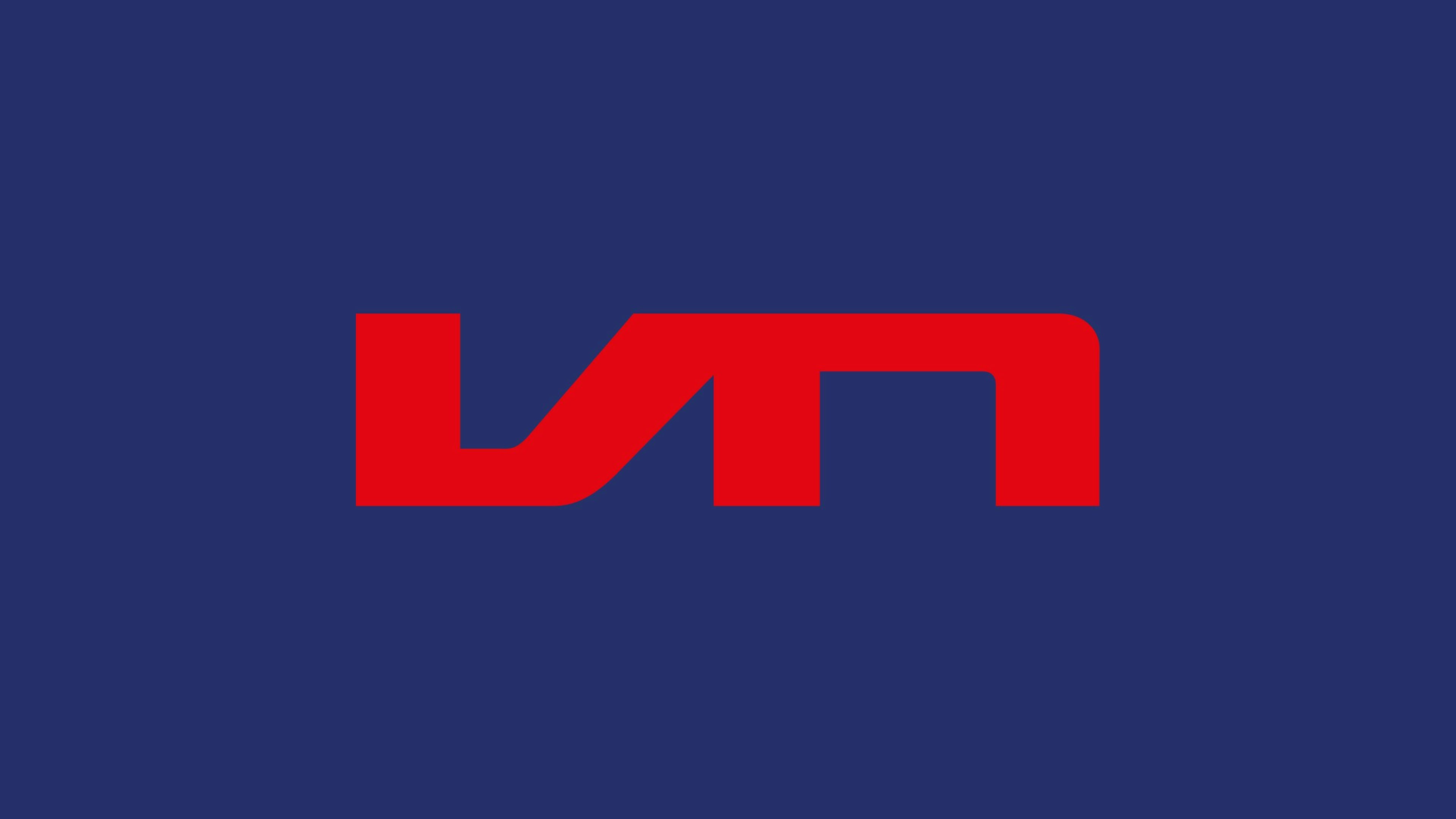 The logo of Vrij Nederland in a red color on a dark blue background