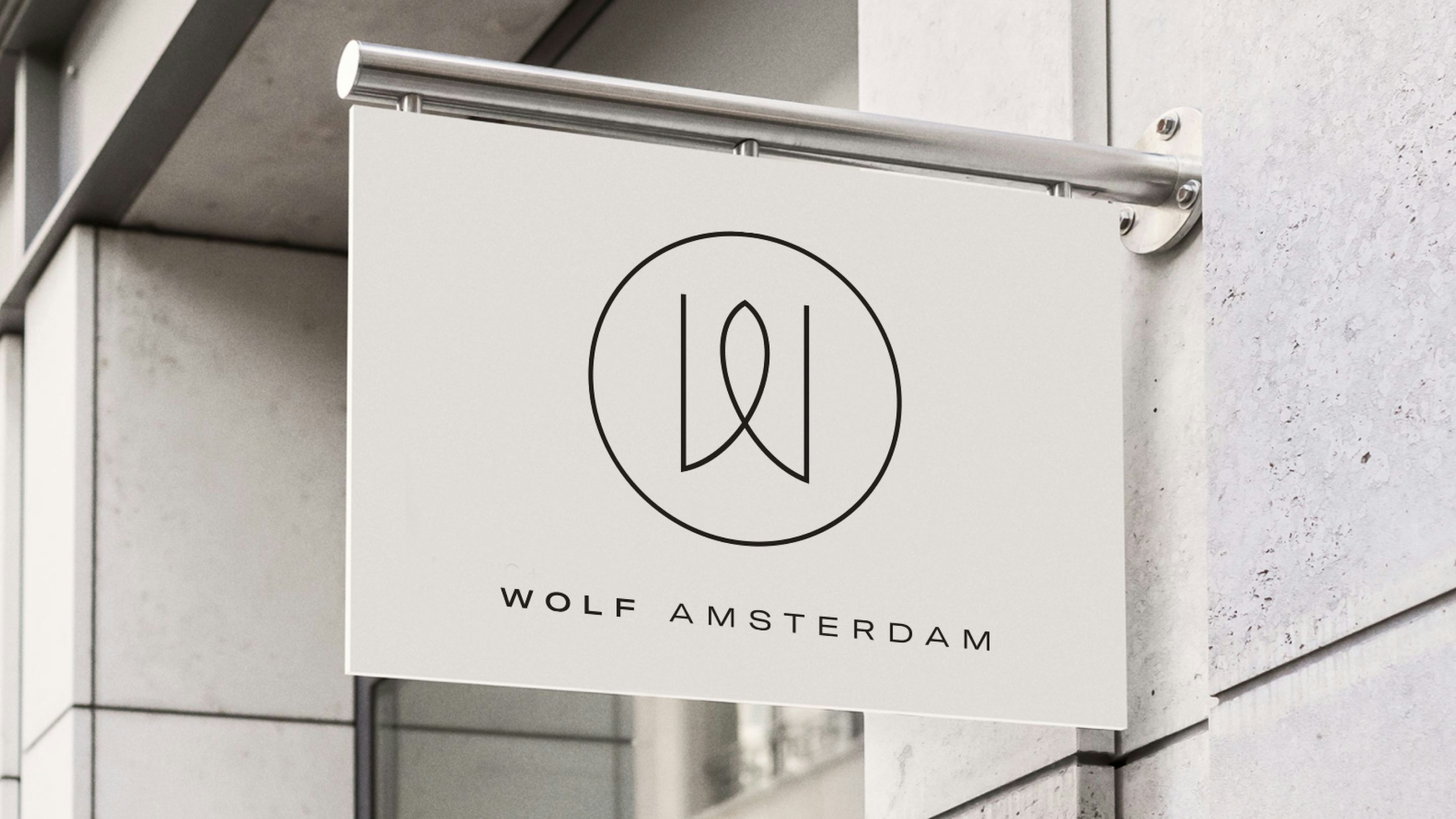 A signboard displaying the logo of Wolf Amsterdam