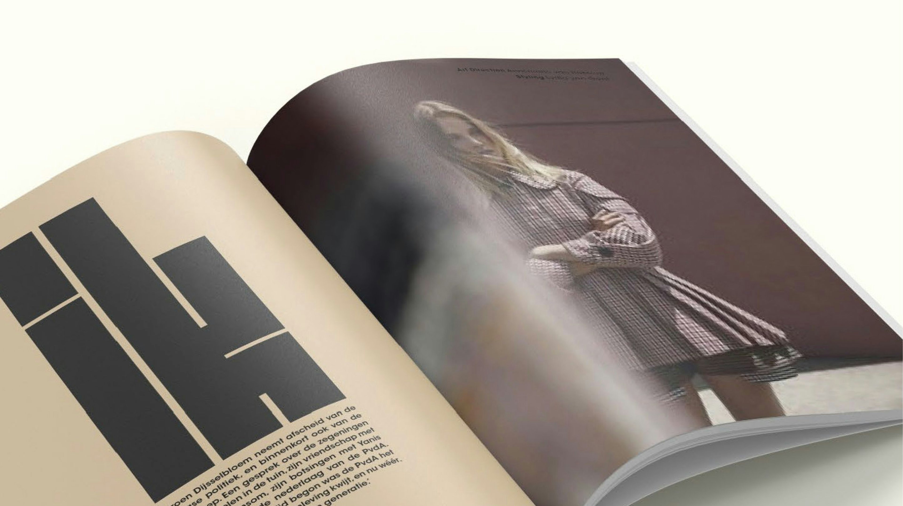 A mockup of an open book with the design of Vrij Nederland