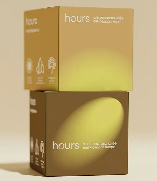 Two stacked boxes of "hours" coffee alternative, with brown and yellow tones, featuring Russian text and small icons.