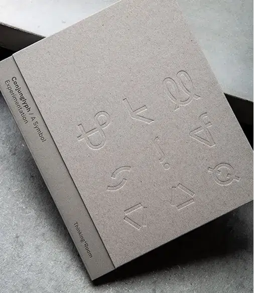 Minimalist book cover with embossed abstract symbols and text reading "Country Rap #4: A Symbol Experimentation" and "Thinking Room" on the spine.