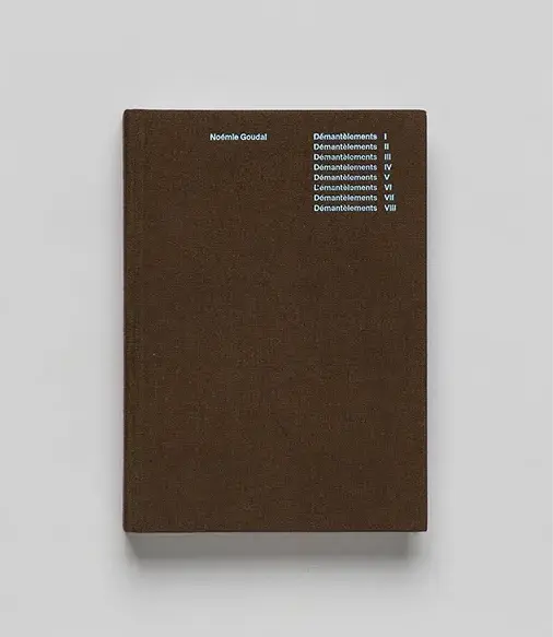 Brown book cover with white text listing "Démantèlement I-VIII" and the author's name, Noémie Goudal, in the top left corner.